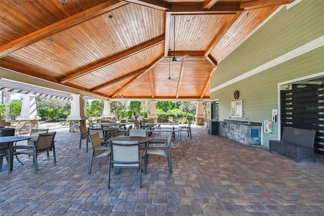 view of patio / terrace featuring a gazebo, area for grilling, and an outdoor stone fireplace