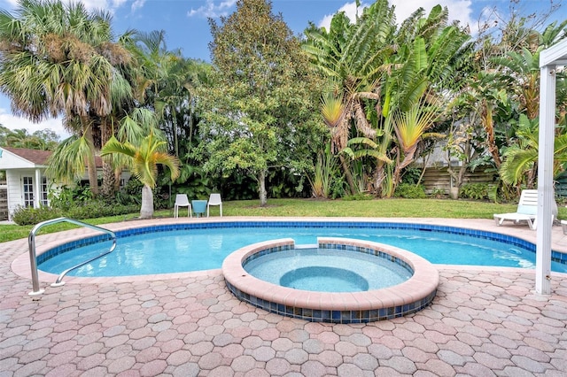 view of pool with an in ground hot tub