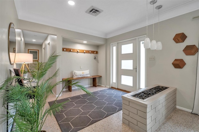 foyer entrance featuring ornamental molding