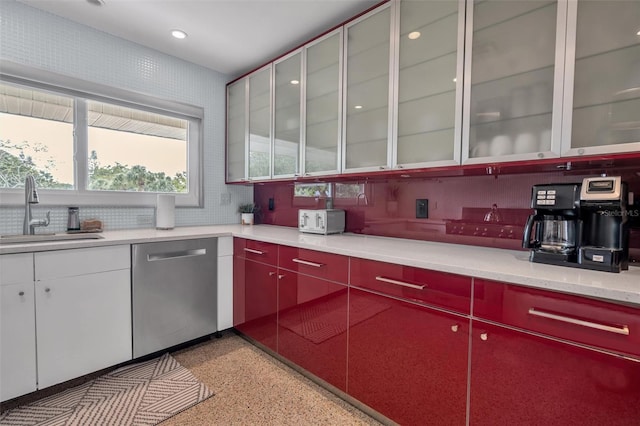 kitchen with backsplash, dishwasher, and sink