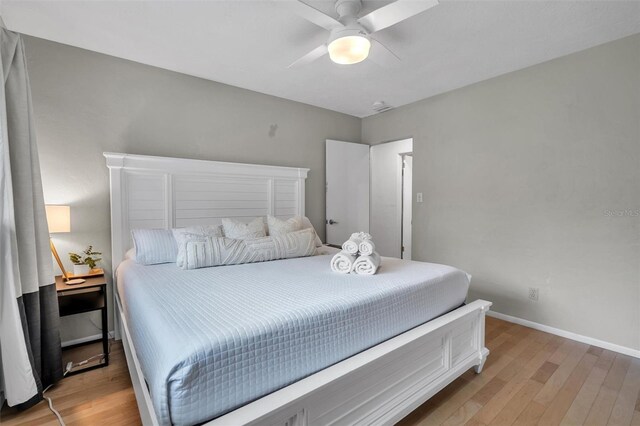 bedroom with hardwood / wood-style flooring and ceiling fan