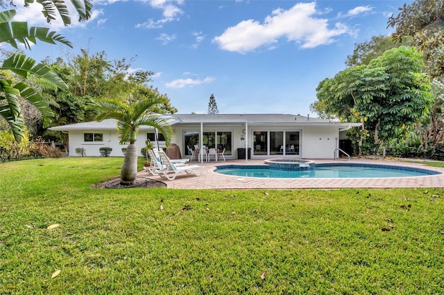 back of house with a swimming pool with hot tub, a patio, and a lawn