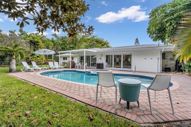 view of swimming pool featuring an in ground hot tub and a patio area