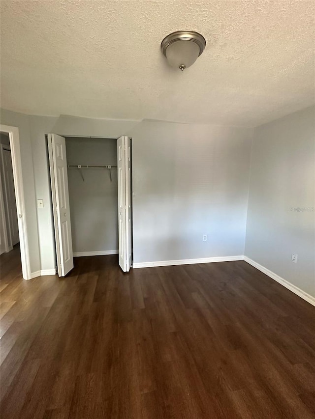 interior space with dark hardwood / wood-style flooring and a textured ceiling