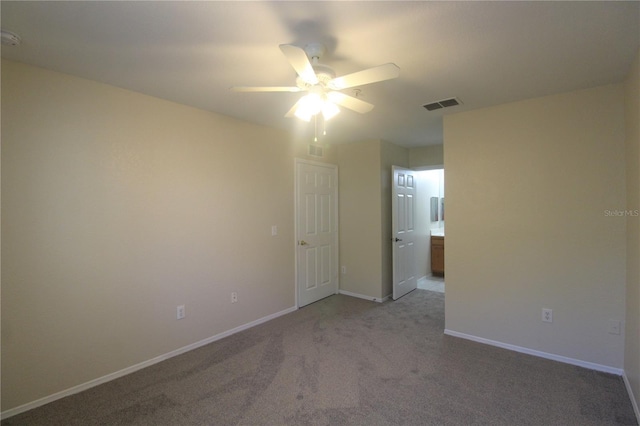 empty room featuring light colored carpet and ceiling fan