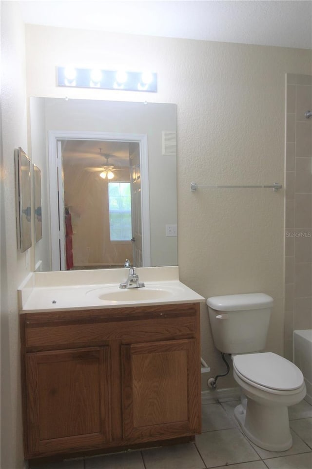 bathroom with ceiling fan, tile patterned flooring, vanity, and toilet