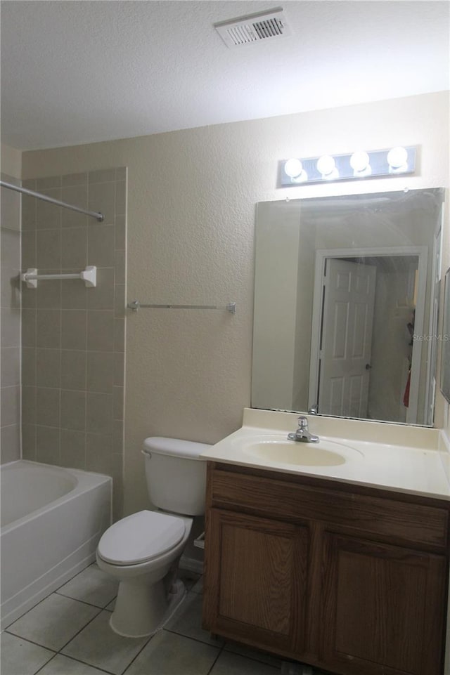 full bathroom with tile patterned flooring, vanity, toilet, and tiled shower / bath combo