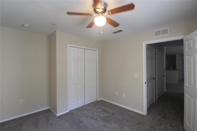 unfurnished bedroom featuring a closet, dark carpet, and ceiling fan