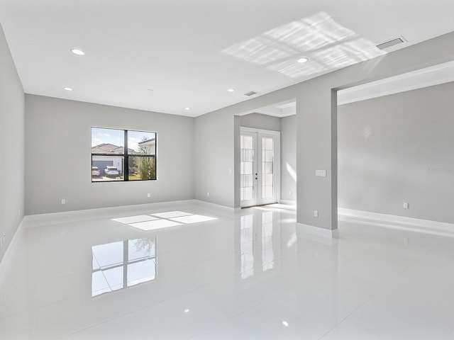 unfurnished room with french doors and light tile patterned floors