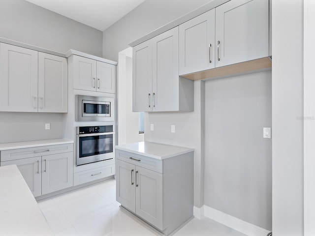 kitchen with light tile patterned flooring and stainless steel appliances