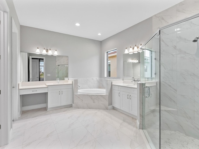 bathroom featuring separate shower and tub, vanity, and a healthy amount of sunlight