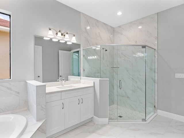 bathroom with vanity and independent shower and bath