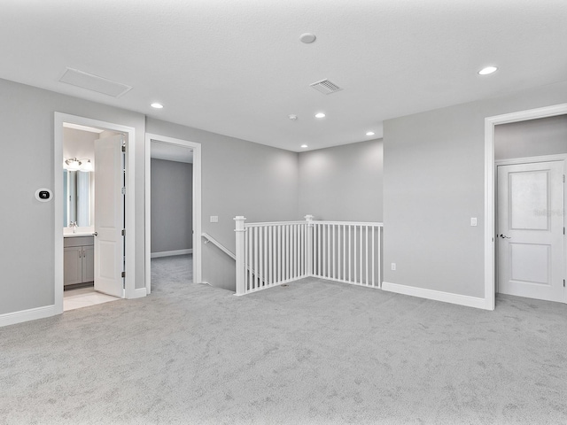 unfurnished room featuring light colored carpet