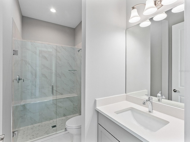 bathroom featuring vanity, toilet, and walk in shower