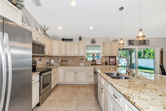 kitchen with pendant lighting, stainless steel appliances, plenty of natural light, and sink