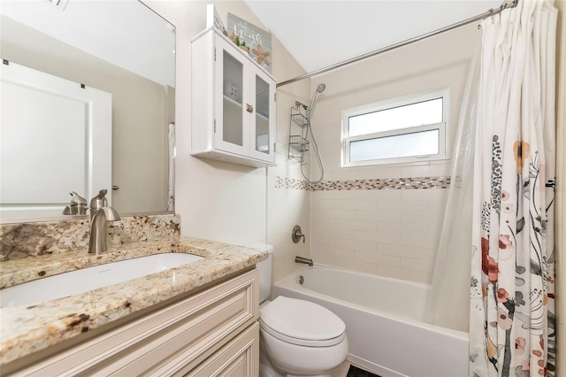 full bathroom with shower / bath combination with curtain, vanity, toilet, and vaulted ceiling