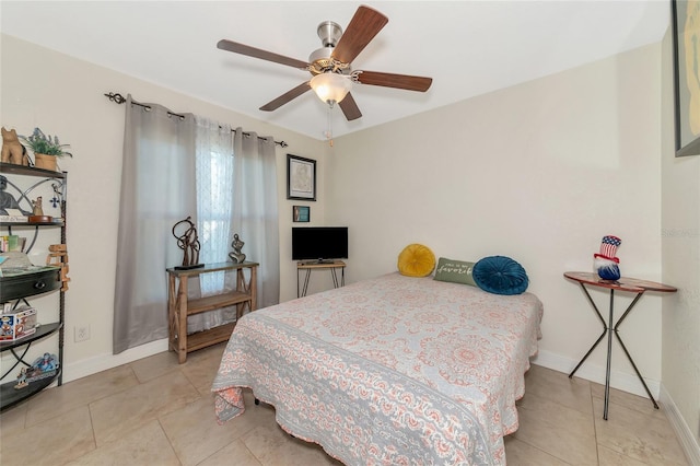 tiled bedroom featuring ceiling fan