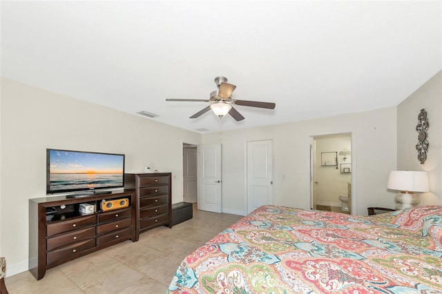 tiled bedroom featuring ensuite bath and ceiling fan