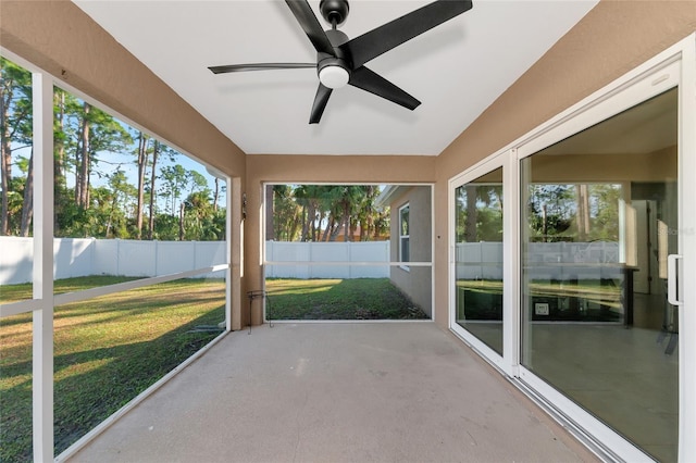 unfurnished sunroom with ceiling fan and a wealth of natural light