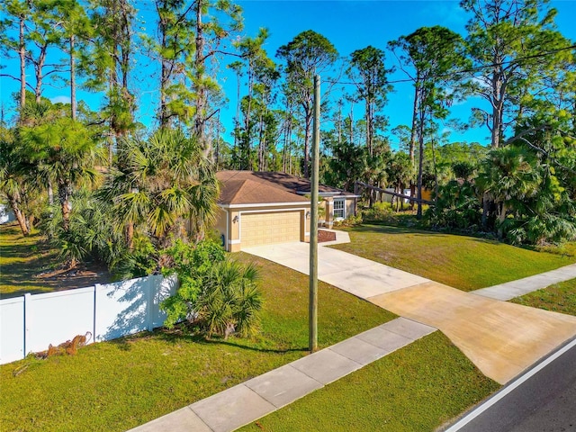 view of front of property with a garage and a front lawn