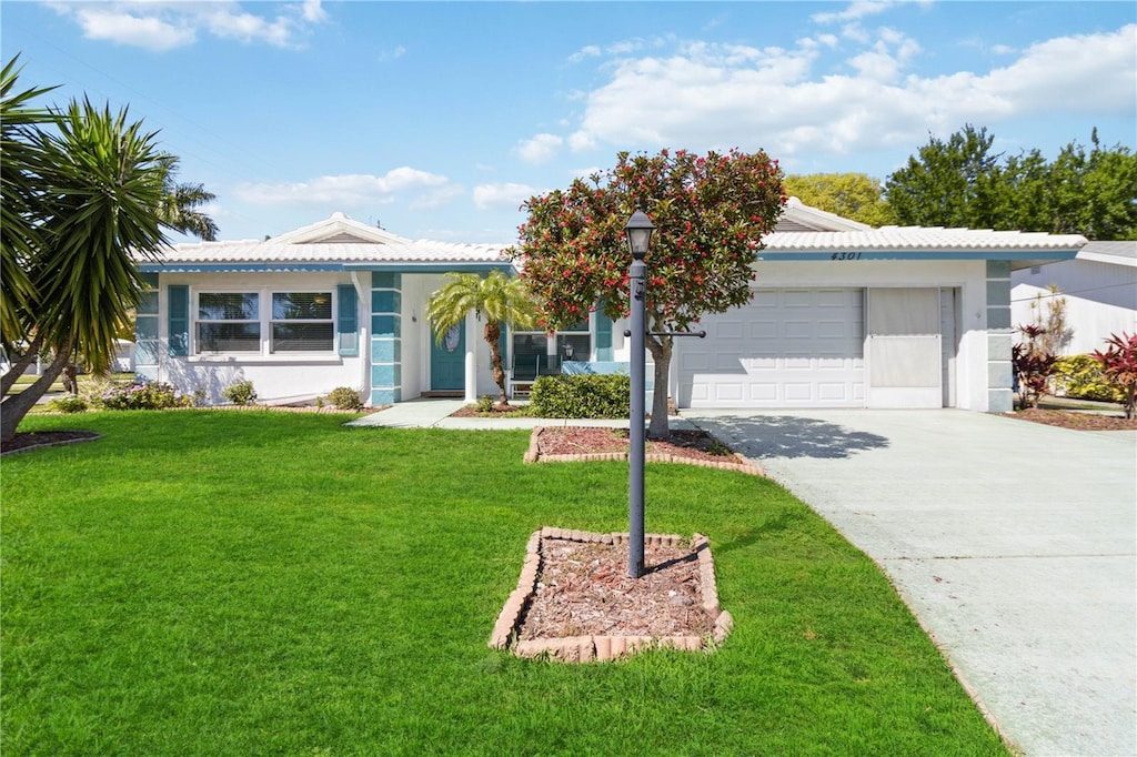 single story home featuring a garage and a front lawn