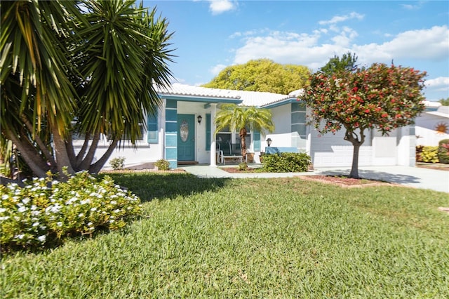 view of front of home with a front yard and a garage