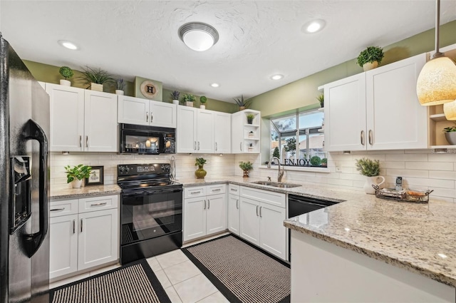 kitchen with white cabinetry, sink, and black appliances