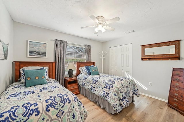 bedroom with ceiling fan, a closet, and light hardwood / wood-style floors