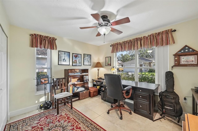 tiled office space featuring ceiling fan