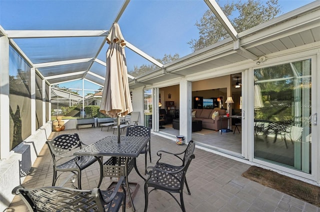 view of patio featuring a lanai