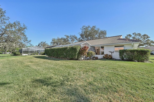 view of front facade featuring a front yard and a lanai