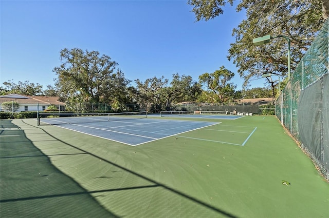 view of tennis court featuring basketball court