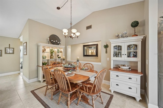 tiled dining room featuring lofted ceiling and a notable chandelier