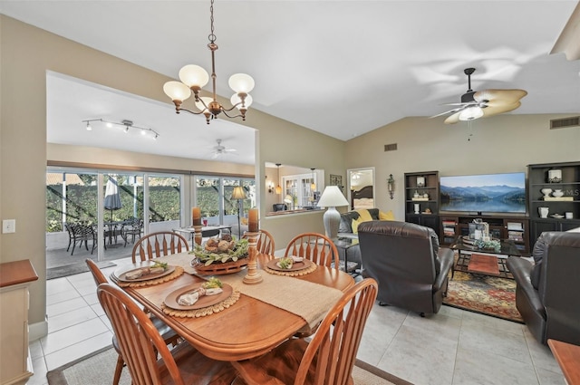 tiled dining room with ceiling fan with notable chandelier and vaulted ceiling