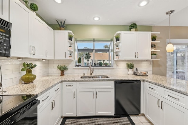 kitchen with black appliances, a healthy amount of sunlight, white cabinetry, and sink