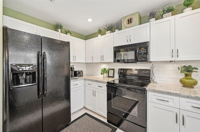 kitchen featuring tasteful backsplash, white cabinetry, and black appliances