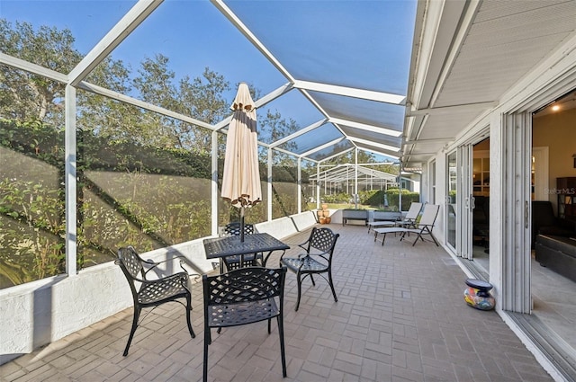 view of patio featuring glass enclosure