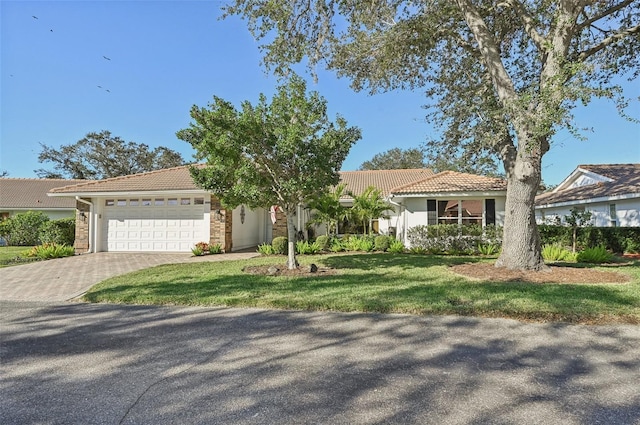 view of front of house with a front yard and a garage