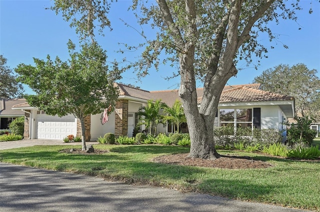 view of front of home with a front lawn and a garage