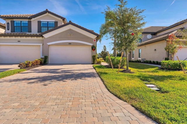 view of front of house featuring a front yard and a garage