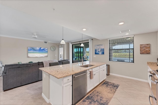 kitchen featuring pendant lighting, white cabinets, sink, an island with sink, and stainless steel appliances