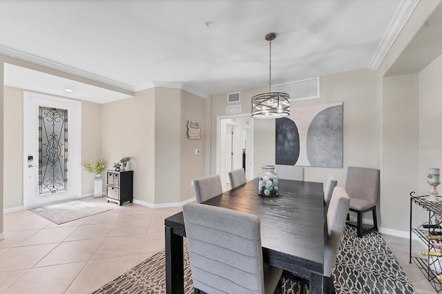 tiled dining room with a chandelier and ornamental molding