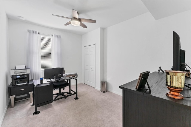 carpeted home office with ceiling fan