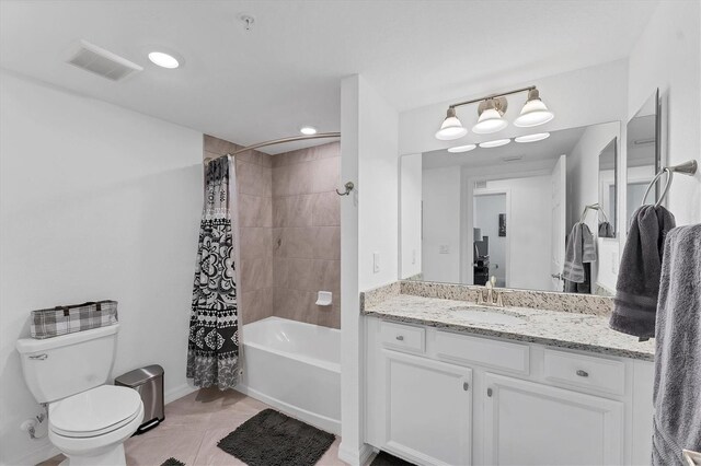 full bathroom with tile patterned flooring, shower / tub combo, vanity, and toilet