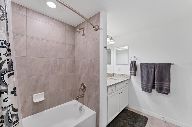 bathroom featuring shower / bath combo with shower curtain and vanity