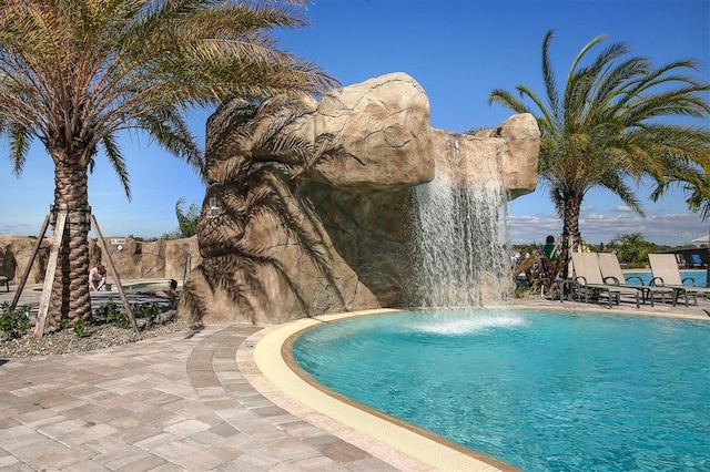 view of pool featuring pool water feature