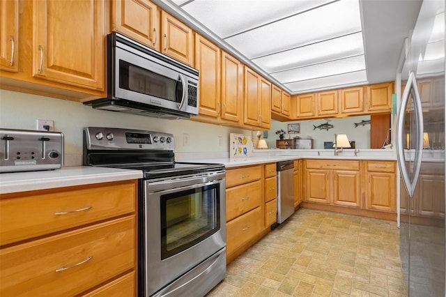 kitchen with appliances with stainless steel finishes and sink