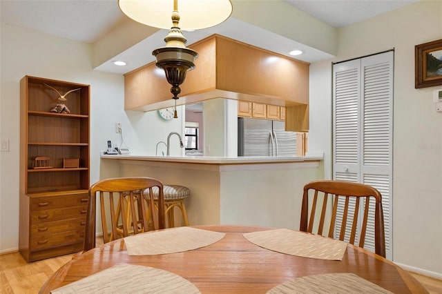 dining area featuring light hardwood / wood-style floors and sink