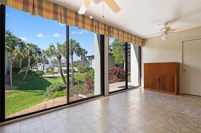 entryway with wooden walls and ceiling fan