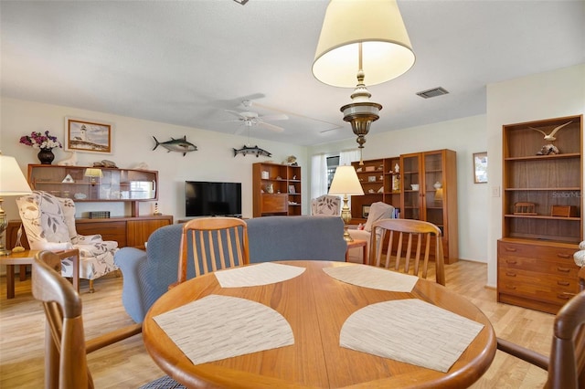 dining area featuring ceiling fan and light hardwood / wood-style floors